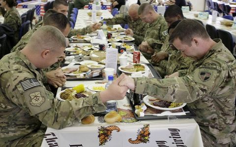 U.S. soldiers pray before eating a Thanksgiving meal at a dining hall at the U.S.-led coalition base in Kabul, Afghanistan, Thursday, Nov. 22, 2012. The dining hall at the U.S.-led coalition base in the Afghan capital served up mac-and-cheese along with traditional Thanksgiving Day fixings. (AP Photo/Musadeq Sadeq)